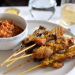 Singaporean Style Chicken and Lamb Satay Marinated, skewered and grilled chicken and lamb slices. Served with cucumber, ketupat rice cakes and spicy peanut sauce.